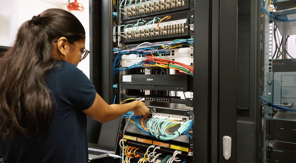 Network engineer performing hands‑on maintenance within enterprise network infrastructure